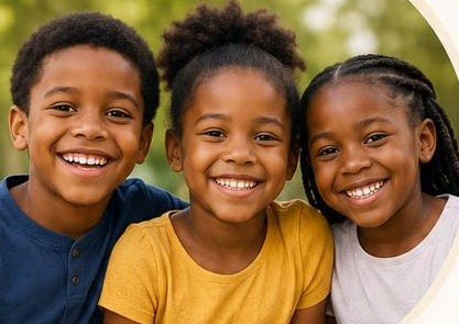 Three smiling children who take part in Hope for Every Generation's youth programs